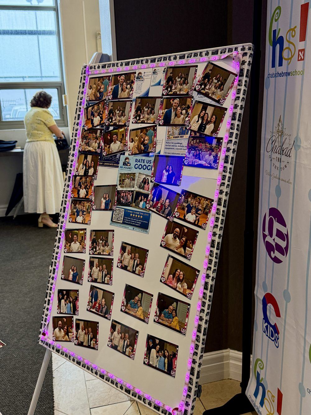 Easel display board covered in custom photo magnets from a Mr. Magnet event in Montreal
