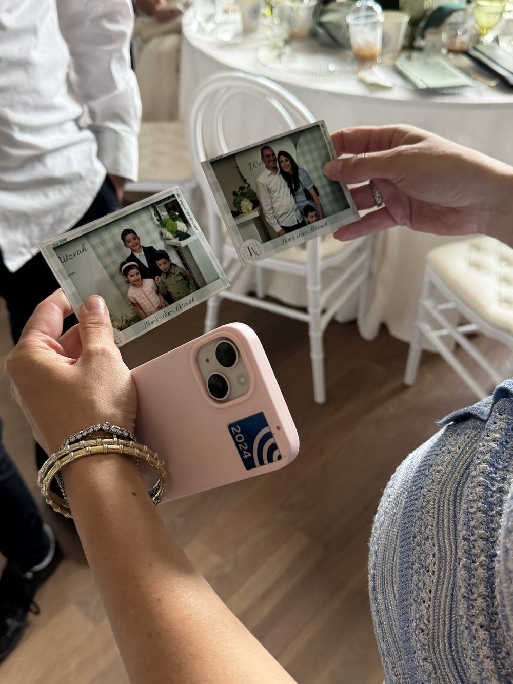 Guests holding their finished custom photo magnets from a Bar Mitzvah